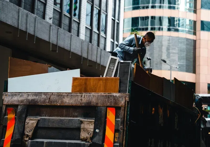 Worker loading debris during a property cleanout